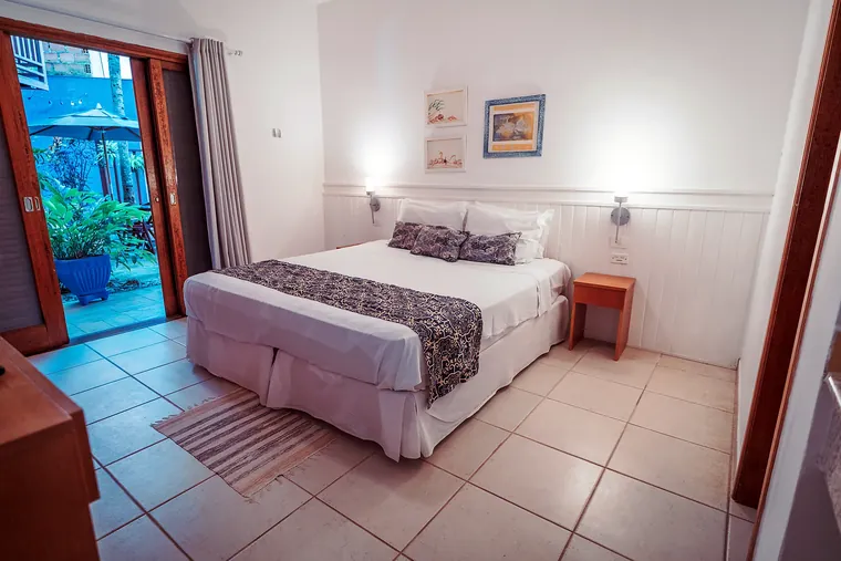 Suíte Junior com porta de correr aberta para o jardim